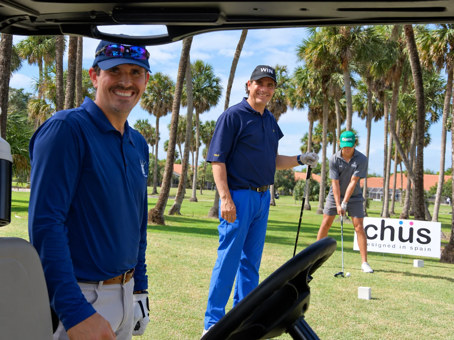 Two players watching a tee shot at the Chus sponsor hole