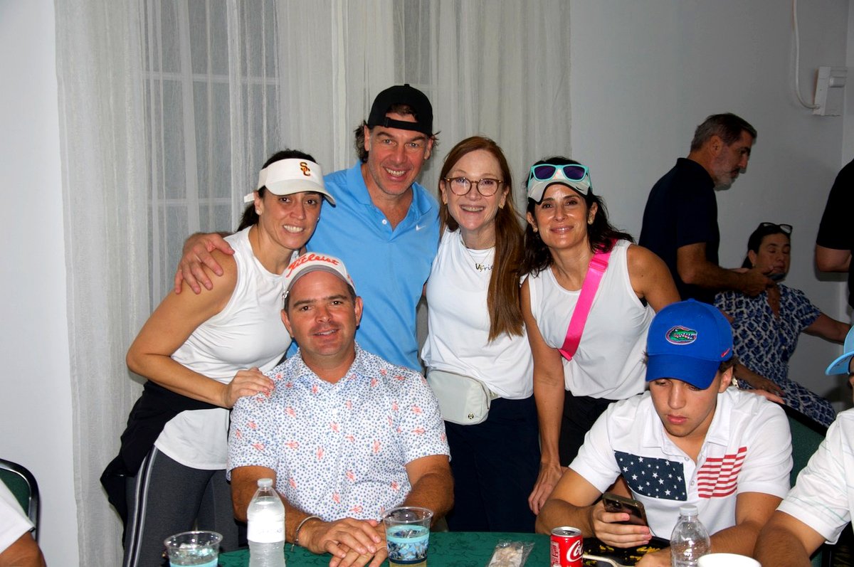 Players gathered around a table in the clubhouse after the round