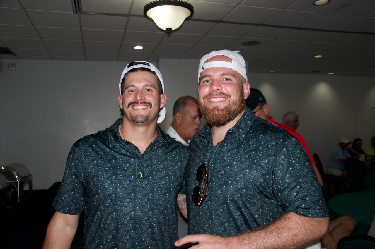 Two players in the clubhouse after the round