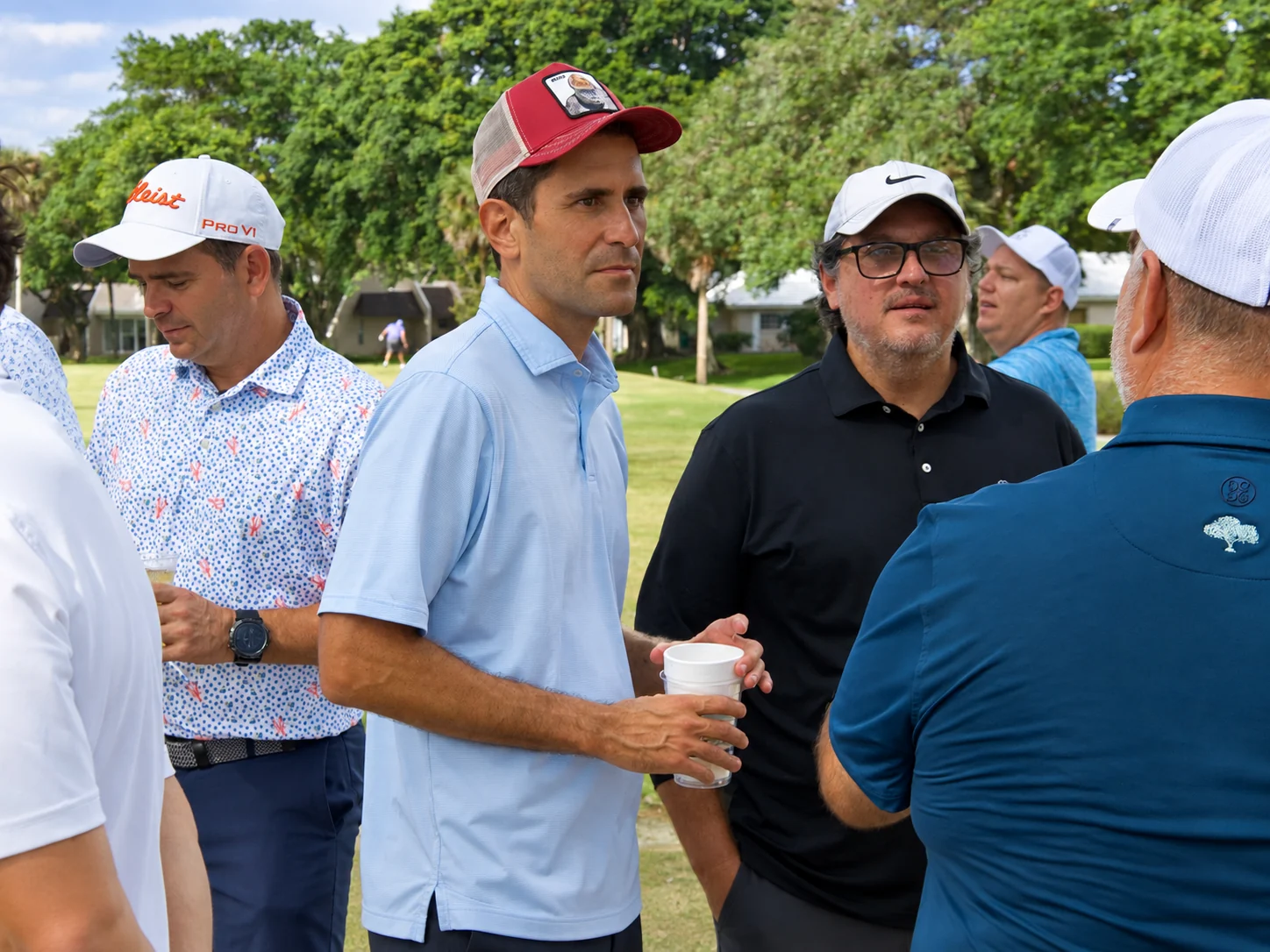 Players talking over drinks after the round