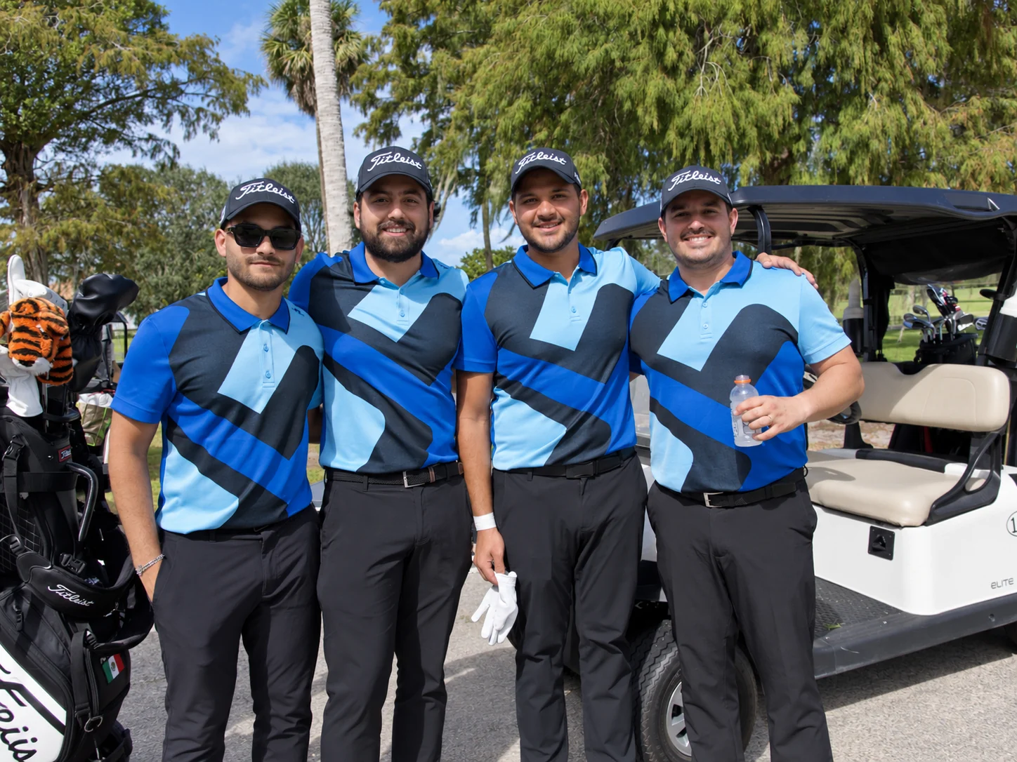 A matching foursome beside their cart before the round