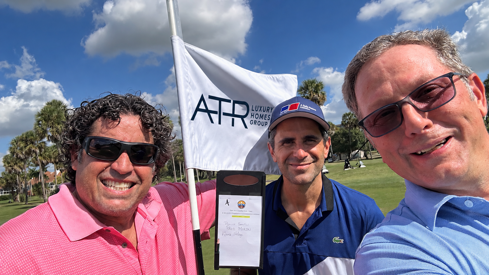 Players at the ATR Luxury Homes Group hole flag, Palm Aire Country Club Oaks Course