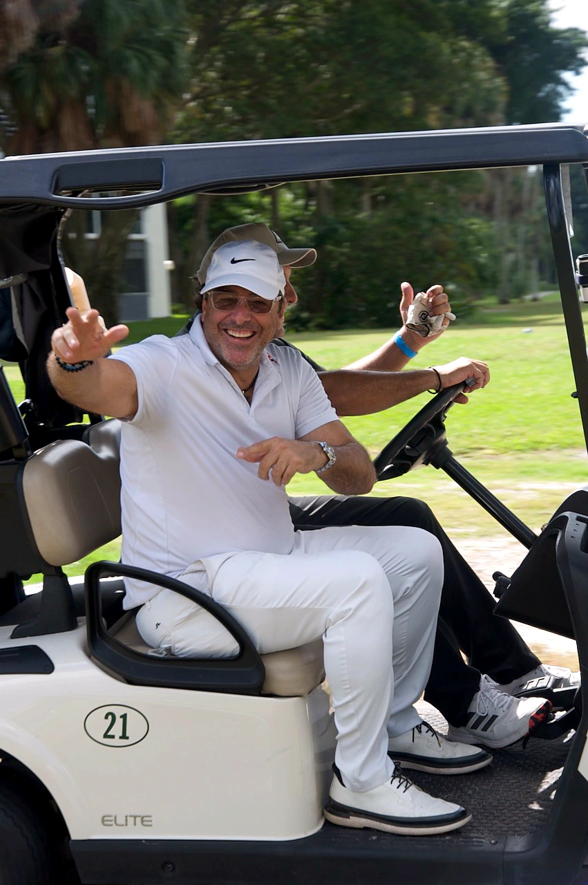 A player pointing from the wheel of cart 21