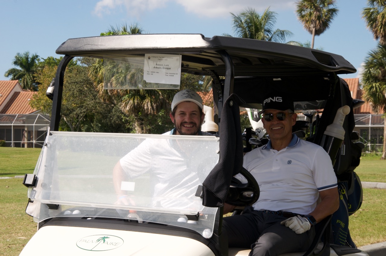 Two players in their cart at Palm Aire