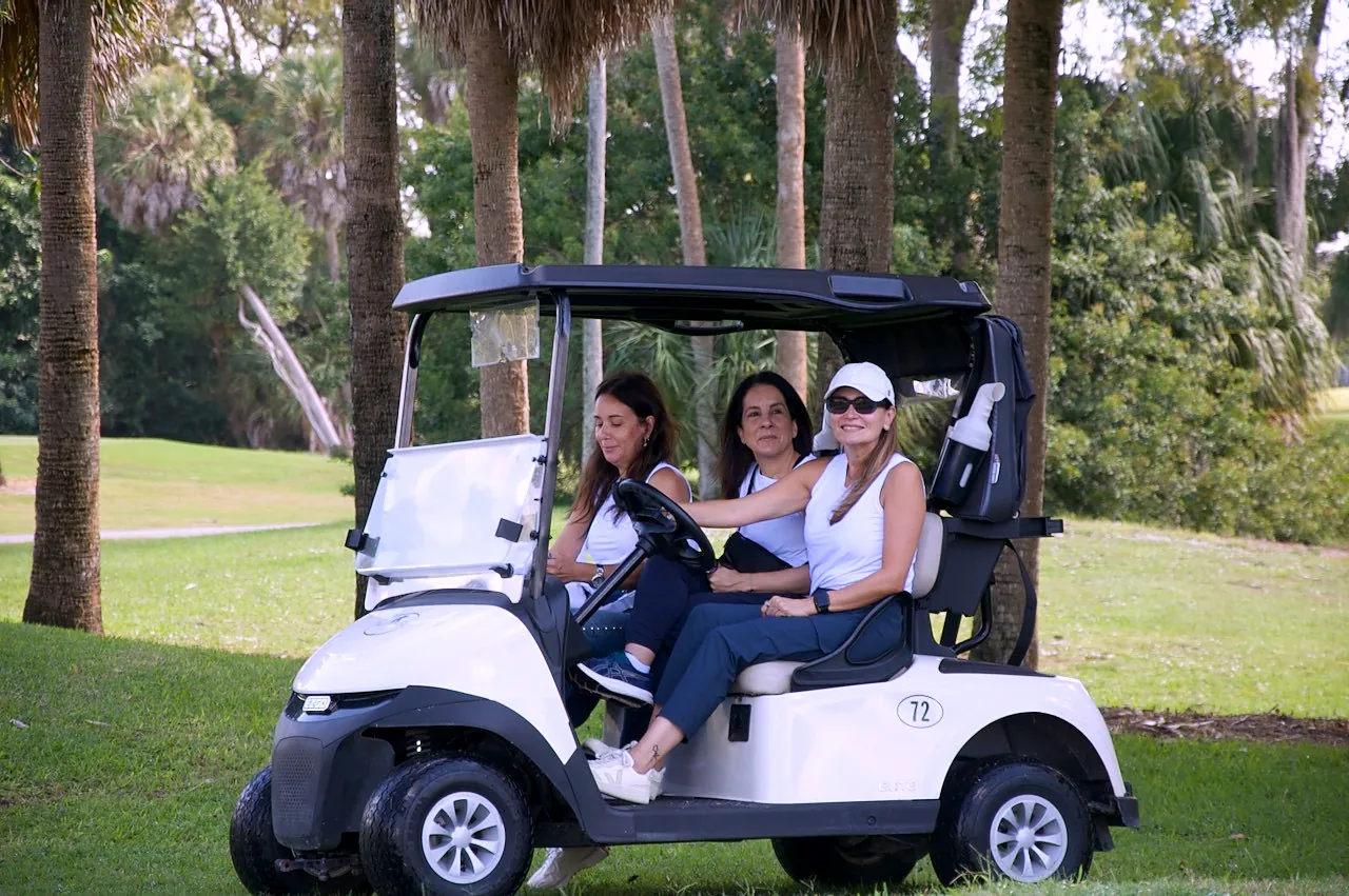 Three players riding out in cart 72