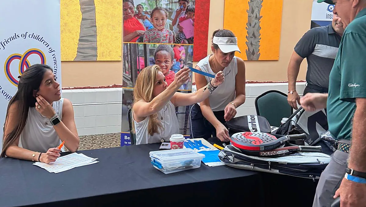 Volunteers handing out wristbands at the registration desk